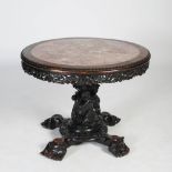 A Chinese dark wood round table, Qing Dynasty, the circular top with mottled red marble insert above