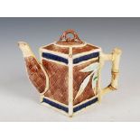 A late 19th century Majolica pottery teapot and cover, with simulated bamboo details, picked out