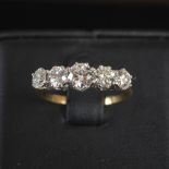 A 20th century five stone diamond ring, centred with a round brilliant cut diamond, calculated to