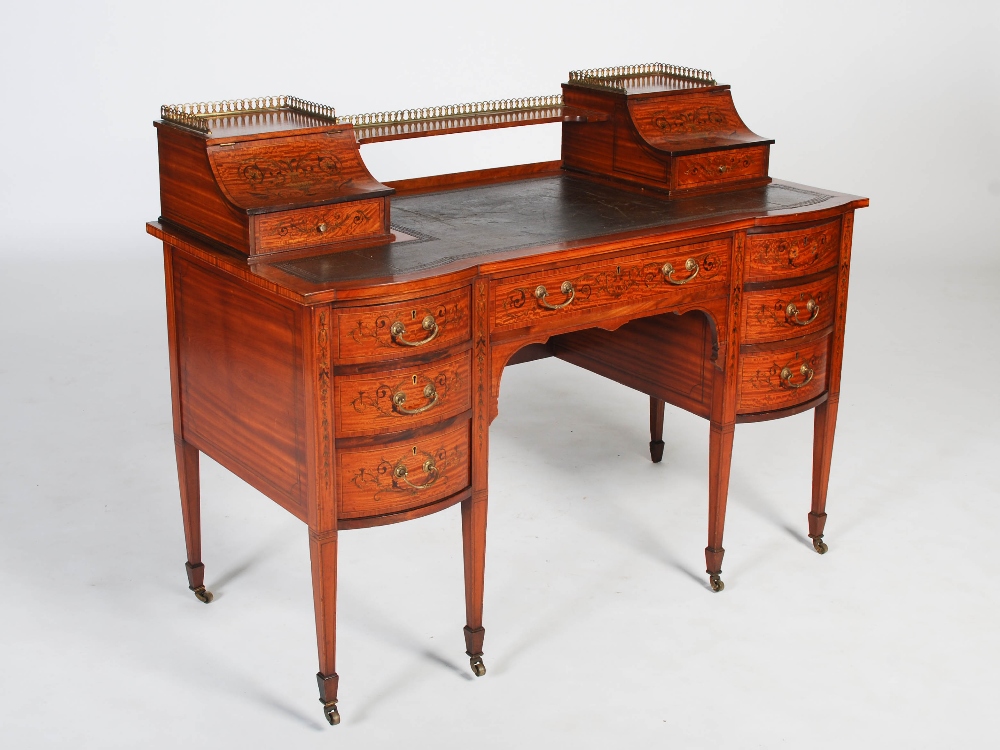 A late 19th century satinwood and marquetry inlaid desk by Maple & Co., the rectangular top with