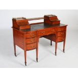 A late 19th century satinwood and marquetry inlaid desk by Maple & Co., the rectangular top with