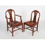 A set of eight George III style mahogany dining chairs, the leather upholstered drop in seats raised