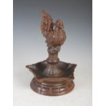 An Asian pottery brown glazed oil lamp in the form of a bird, 27cm high x 20cm diameter.