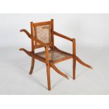 An early 20th century folding bathing chair, with cane work back and seat, the reverse inscribed '