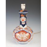 A Japanese Imari bottle vase converted to a table lamp, Meiji Period, decorated with oval shaped