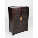 A Chinese dark wood side cabinet, 20th century, the panelled rectangular top above two panelled