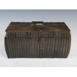 A 19th century Anglo-Indian horn and sandalwood sarcophagus shaped tea caddy, the hinged rectangular