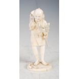 A Japanese ivory okimono of a farm worker, Meiji Period, carved standing holding a rake in his