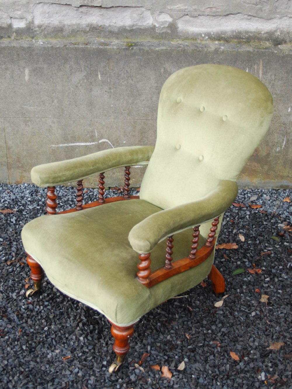 A Victorian walnut armchair, the velvet upholstered back, arms and seat raised on tapered