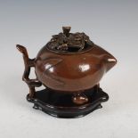A Chinese bronze censer and cover in the form of a peach, Qing Dynasty, the cover pierced with