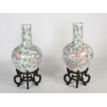 A large pair of modern Chinese porcelain vases on stands, 20th century, decorated with fruiting
