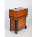 An early 19th century burr walnut and ebonised Davenport, the rectangular top with pull up section