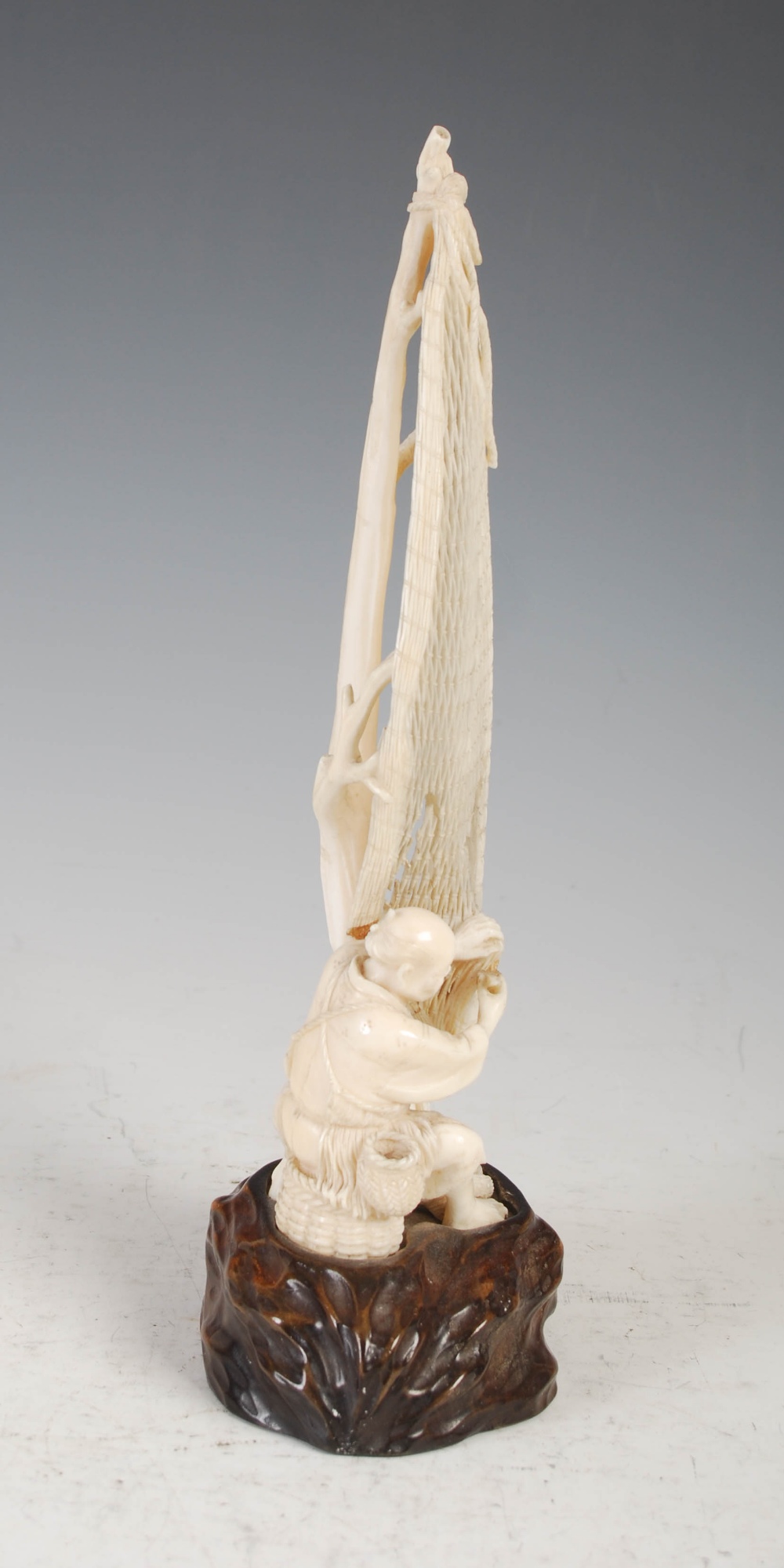 A Japanese ivory okimono of a fisherman tending net, Meiji Period, on carved wood stand, overall - Image 4 of 9