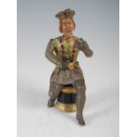 A 19th century Continental white and yellow metal figure of a seated Knight, with coloured