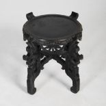 A Chinese dark wood jardiniere stand, late 19th/early 20th century, the circular top raised on
