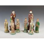 A group of eight Chinese porcelain immortals, comprising; two tall aubergine glazed figures, 30cm