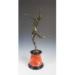 After Bruno Zach, a bronze figure of an Art Deco Dancer, raised on a black and mottled red marble