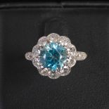 A 20th century blue zircon and diamond cluster ring, centred with a round faceted blue zircon,