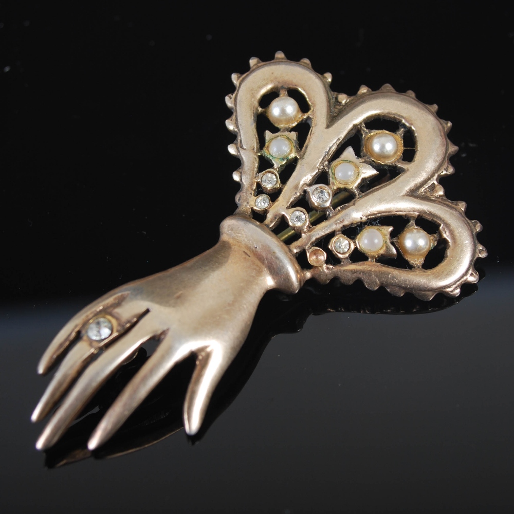 An early 20th century white metal, paste and simulated split pearl brooch in the form of a hand, - Image 4 of 4