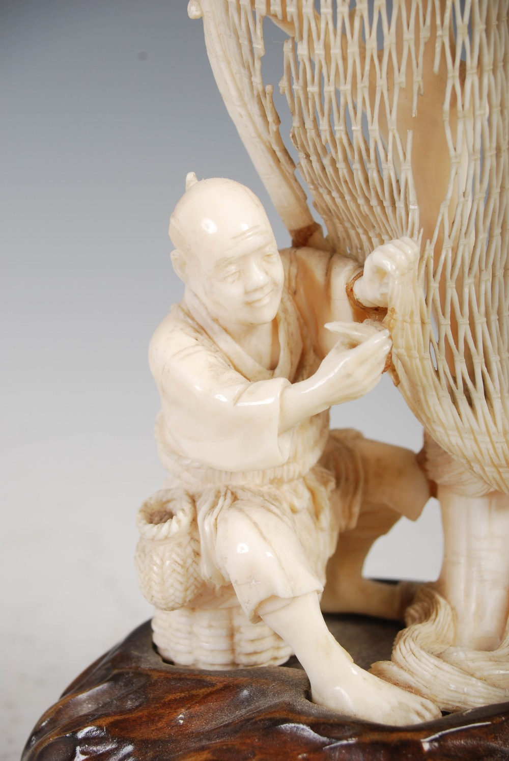 A Japanese ivory okimono of a fisherman tending net, Meiji Period, on carved wood stand, overall - Image 5 of 9