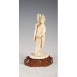 A Japanese ivory okimono of a bijin on carved wood stand, Meiji Period, carved standing holding a