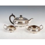 A George V silver three piece tea set, Sheffield, 1912, makers mark of WF over AF, circular shaped