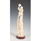 A Japanese ivory okimono of Shou Lao and boy, Meiji Period, on carved wood stand, 32.5cm high.