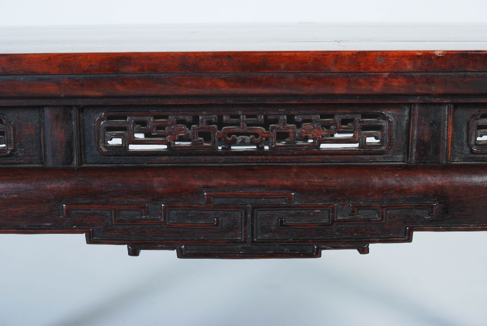 A Chinese dark wood low table, Qing Dynasty, the rectangular panelled top above a pierced and scroll - Image 4 of 5