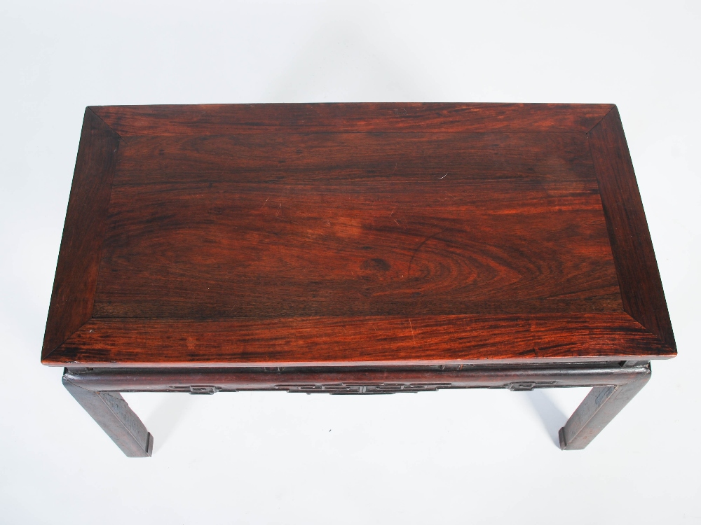 A Chinese dark wood low table, Qing Dynasty, the rectangular panelled top above a pierced and scroll - Image 5 of 5