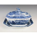 A Chinese porcelain blue and white tureen, cover and stand, Qing Dynasty, decorated with pavilions