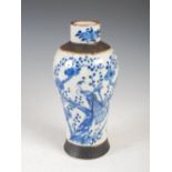 A Chinese porcelain blue and white crackle glazed jar, Qing Dynasty, decorated with a pair of