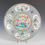 A Chinese porcelain famille rose blue ground charger, late Qing Dynasty, decorated with a circular