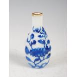 A Chinese porcelain blue and white snuff bottle, decorated in relief with dark blue enamel flowers