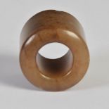 A Chinese russet jade archers ring, 3.5cm diameter x 3cm deep.