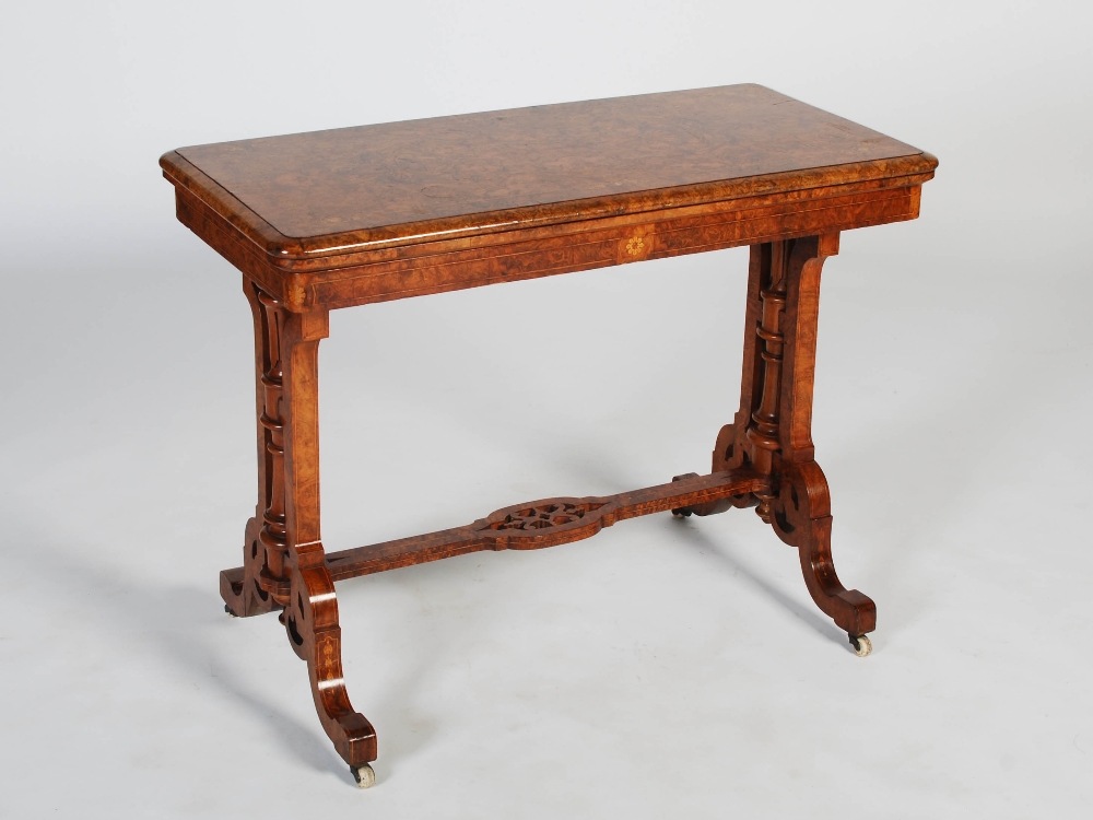 A Victorian walnut and marquetry inlaid card table, the hinged rectangular top with a moulded edge