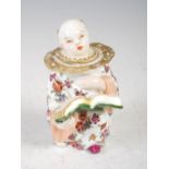 A late 19th/ early 20th century Continental porcelain inkwell in the form of a Chinese boy reading a