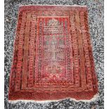 An Eastern prayer mat, early 20th century, the rectangular field decorated with a temple, within
