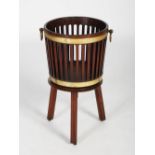 A 19th century mahogany and brass bound bucket on stand, the tapered cylindrical bucket with pierced