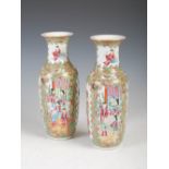 A pair of Chinese porcelain famille rose Canton vases, Qing Dynasty, decorated with panels of