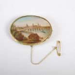 A late 19th century Continental gilt metal mounted porcelain brooch, the oval porcelain panel