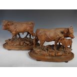 A fine pair of late 19th century Black Forest carved wood cow groups, comprising; bull on