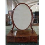 A large 19th century mahogany and boxwood lined dressing table mirror, the oval mirror plate on a