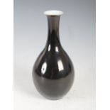 A Chinese porcelain monochrome glazed famille noir bottle vase, Qing Dynasty, 21.5cm high.