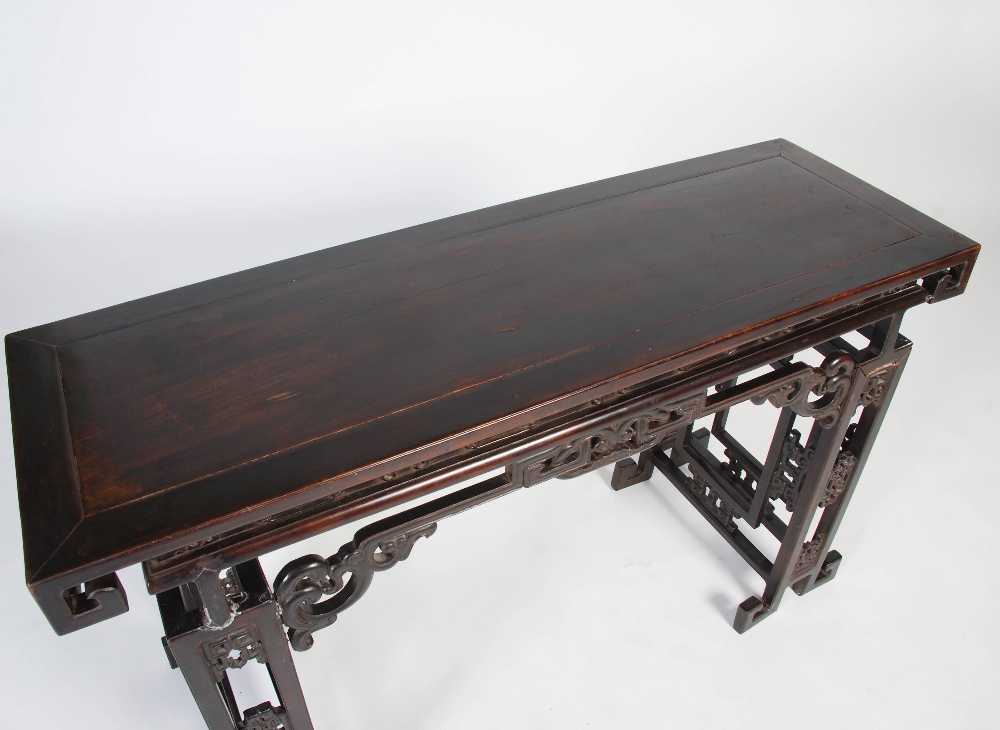 A Chinese dark wood table, late 19th/early 20th century, the rectangular panelled top above a - Image 2 of 10