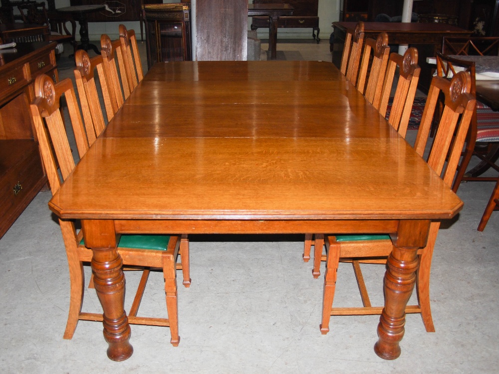 A late 19th century oak dining room room suite, comprising; an extending dining table enclosing four - Image 6 of 9