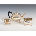 A George V three piece silver tea set, Sheffield 1915, makers mark of Walker & Hall, oval shaped,