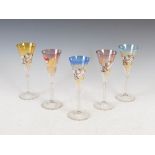 Five German mid 20th century clear and coloured champagne flutes, with enamelled and gilded bowls,