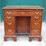 A George III mahogany knee hole desk, the rectangular top with a moulded edge above a green baize