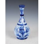 A Macintyre Moorcroft blue ground Florian ware pottery vase, brown printed marks, green painted