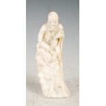 A Japanese ivory okimono on an immortal, Meiji Period, 12cm high.